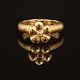 A 14kt golf "Flower" ring by Charlotte Lynggaard, Copenhagen. Ringsize: 58. W. 
8,7gr