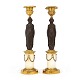 A pair of fire gilt bronze candle sticks. France circa 1830. H: 28cm