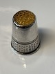 Silver finger ring with yellow flounce.