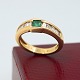 Ring in 18k gold set with diamonds and emerald