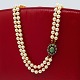 Pearl necklace with a 14k gold clasp, set with emerald and diamonds