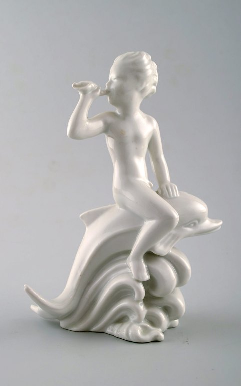 Harald Salomon for Rörstrand, blanc de chine/hvidglaseret figur forestillende 
faun/panfigur ridende på delfin.