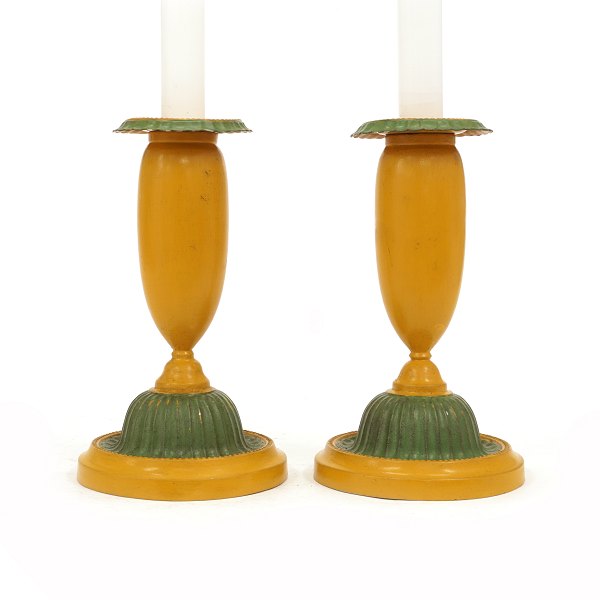 A pair of green and yellow decorated pair of candle sticks. Denmark circa 
1840-50. H: 19cm