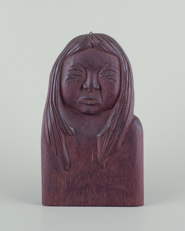 Greenlandica, wood relief of a Greenlandic woman.